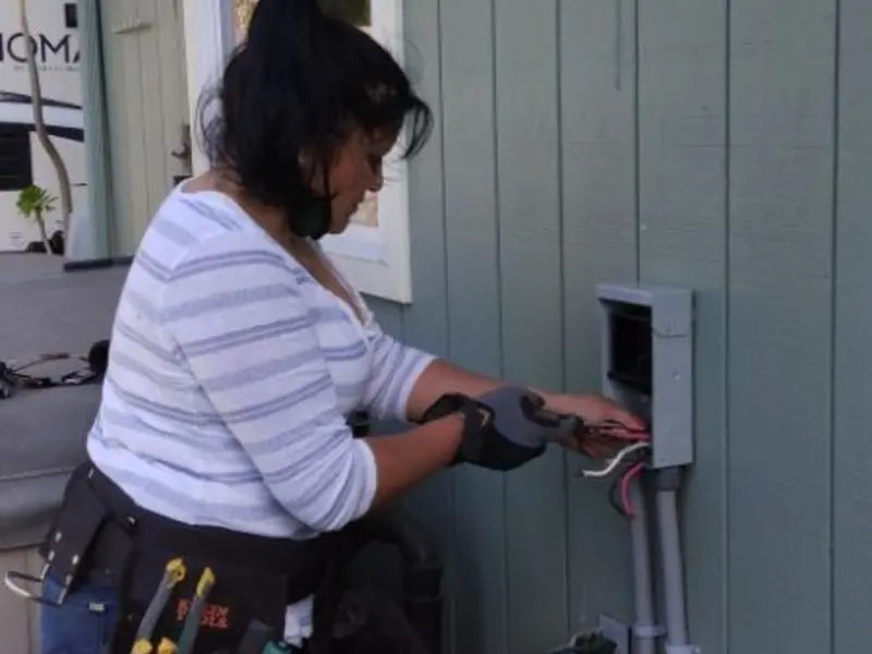 Licensed electrician wiring an exterior subpanel in Monument
